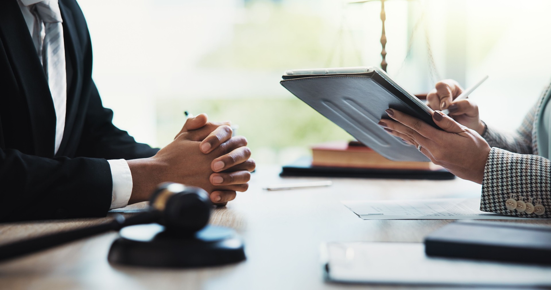Reunión de manos, personas y legal con tablet, firma y revisión de contratos para el cumplimiento de la empresa. Abogado, abogado y técnico para consultas, documentos digitales y comentarios en un bufete de abogados corporativos