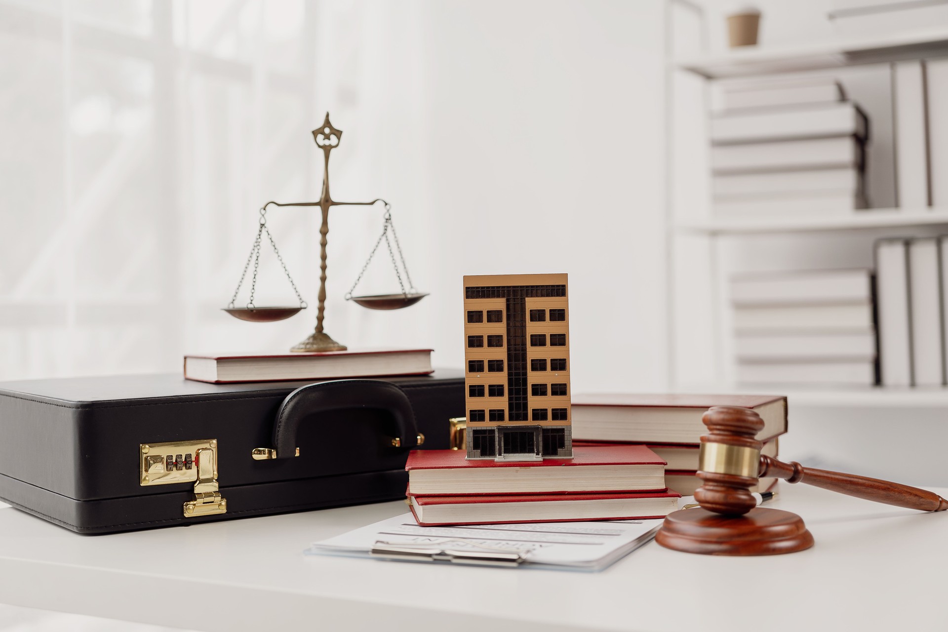There is real estate auction, legal system, law and justice, real estate house auction concept. Judge hammer on wooden table in front of house model
