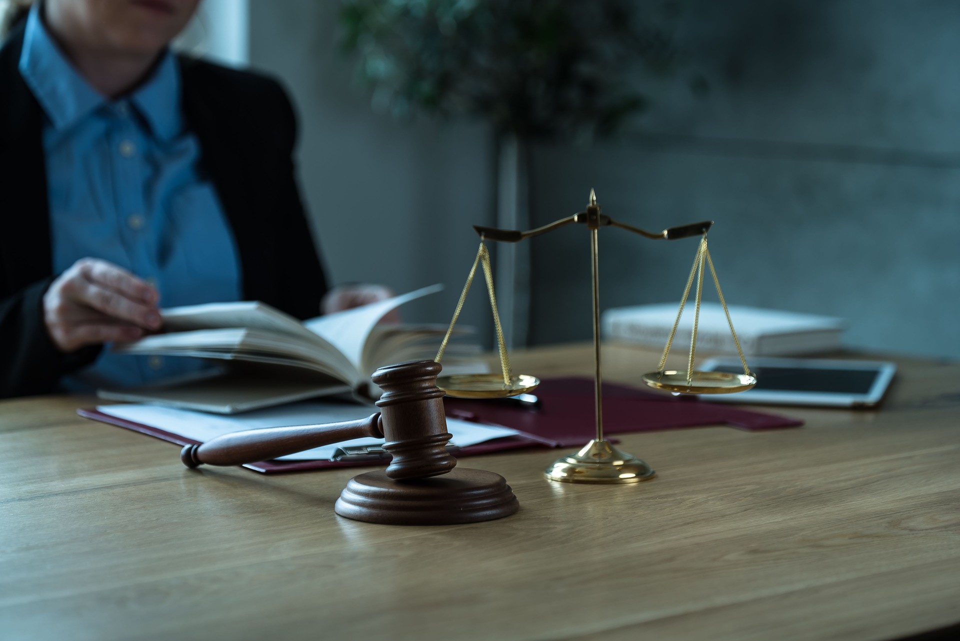 Oficina de abogados. Estatua de la Justicia con escalas y abogado trabajando en papeles, consejo y concepto de justicia.